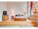 Bright bedroom features hardwood floors, brick wall, large window and a modern bed frame at 170 Boulevard # H201, Atlanta, GA 30312