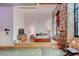 Bright bedroom features hardwood floors, brick wall, large window and a modern bed frame at 170 Boulevard # H201, Atlanta, GA 30312