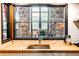 Bright kitchen view highlights the countertops, stainless steel sink, and oversized windows at 170 Boulevard # H201, Atlanta, GA 30312