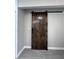 Bathroom features a modern barn door and neutral tile flooring that enhance the space at 1740 Emerald Ave Ave, Atlanta, GA 30310