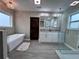 Bright bathroom with a soaking tub, double vanity, and glass-enclosed shower at 1740 Emerald Ave Ave, Atlanta, GA 30310