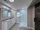 Bathroom featuring double sinks, marble shower and rustic sliding door at 1740 Emerald Ave Ave, Atlanta, GA 30310