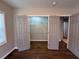 Bedroom with a closet behind double doors and hardwood floors enhances the house's charm at 1740 Emerald Ave Ave, Atlanta, GA 30310