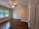 Sunlit bedroom with hardwood floors, neutral walls, and a ceiling fan at 1740 Emerald Ave Ave, Atlanta, GA 30310