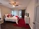 Comfortable bedroom featuring a plush bed, ceiling fan, and a stylish sliding barn door at 1740 Emerald Ave Ave, Atlanta, GA 30310