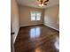 Bright bedroom with hardwood flooring and large window overlooking the street at 1740 Emerald Ave Ave, Atlanta, GA 30310