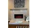 Modern fireplace with a sleek white mantle and decorative tile surround, adding a touch of elegance at 1740 Emerald Ave Ave, Atlanta, GA 30310