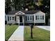 Charming one-story home with a well-manicured lawn and inviting walkway to the front door at 1740 Emerald Ave Ave, Atlanta, GA 30310