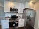 Updated kitchen with stainless steel appliances, granite countertops, and ample cabinet space at 1740 Emerald Ave Ave, Atlanta, GA 30310