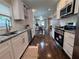 Bright kitchen featuring white cabinets, granite countertops, and stainless steel appliances at 1740 Emerald Ave Ave, Atlanta, GA 30310
