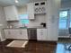 Modern kitchen with white cabinets, granite countertops, and stainless steel appliances at 1740 Emerald Ave Ave, Atlanta, GA 30310