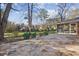 Expansive stone patio leads to a beautifully maintained backyard, creating an inviting outdoor living space at 3226 Custer Lake Nw Dr, Marietta, GA 30064