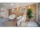 Stylish sunroom featuring comfortable seating, brick accents, and ample natural light. Perfect for relaxation and entertaining at 3226 Custer Lake Nw Dr, Marietta, GA 30064