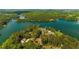 Picturesque aerial view of a lakeside community surrounded by lush green forests and pristine blue waters at 3445 Strawberry Ln, Cumming, GA 30041