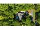 Aerial view of home nestled among lush green trees and well manicured lawns at 3445 Strawberry Ln, Cumming, GA 30041