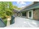 Large wooden back deck with access to a lush backyard and exterior of the brick home at 3445 Strawberry Ln, Cumming, GA 30041