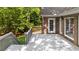 The exterior of a brick house features a spacious back deck overlooking a lush tree line at 3445 Strawberry Ln, Cumming, GA 30041