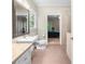 Bright bathroom with a large window, pedestal sink, and access to an adjoining room at 3445 Strawberry Ln, Cumming, GA 30041