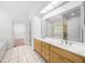 Bathroom featuring double vanity, tile floors, a large mirror, and access to the tub and shower at 3445 Strawberry Ln, Cumming, GA 30041