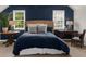 Inviting bedroom with a wicker headboard, accent wall, and plenty of natural light at 3445 Strawberry Ln, Cumming, GA 30041
