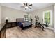 Spacious bedroom with natural light and a ceiling fan, plus a bonus workout space at 3445 Strawberry Ln, Cumming, GA 30041
