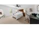 Inviting bedroom with a comfy bed, a ceiling fan, a desk area, and abundant natural light for a peaceful retreat at 3445 Strawberry Ln, Cumming, GA 30041