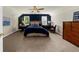Spacious bedroom with an accent wall, wicker headboard and large dresser at 3445 Strawberry Ln, Cumming, GA 30041
