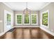 This bright breakfast nook includes a chandelier, access to the deck, and scenic backyard views at 3445 Strawberry Ln, Cumming, GA 30041