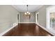 This spacious dining room features decorative molding, a stylish chandelier, and plenty of natural light at 3445 Strawberry Ln, Cumming, GA 30041