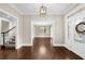 Spacious foyer featuring hardwood floors, elegant lighting, and a staircase to the upper level at 3445 Strawberry Ln, Cumming, GA 30041