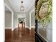 Elegant foyer with hardwood floors, decorative lighting, and a view into the living spaces at 3445 Strawberry Ln, Cumming, GA 30041