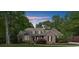 Traditional brick home with dormer windows, dark shutters, and a well-maintained lawn at 3445 Strawberry Ln, Cumming, GA 30041