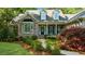Inviting brick home featuring a covered porch, bay window, and professionally landscaped front yard at 3445 Strawberry Ln, Cumming, GA 30041