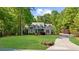 Beautiful brick house with a large front yard, mature trees, and circular driveway at 3445 Strawberry Ln, Cumming, GA 30041