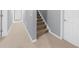 Hallway features neutral carpeting and paint, white doors and trim, and staircase access, creating a clean and functional space at 3445 Strawberry Ln, Cumming, GA 30041