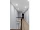 Well-lit upstairs hallway with neutral carpets and ample recessed lighting at 3445 Strawberry Ln, Cumming, GA 30041