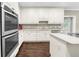 This bright kitchen features stainless steel appliances, white cabinets, and granite countertops at 3445 Strawberry Ln, Cumming, GA 30041