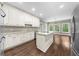 The kitchen offers white cabinets, granite countertops, a kitchen island, and stainless steel appliances at 3445 Strawberry Ln, Cumming, GA 30041