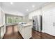 Spacious kitchen featuring stainless steel appliances, a kitchen island, and abundant natural light at 3445 Strawberry Ln, Cumming, GA 30041