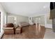 Cozy living room area with neutral colors, hardwood floors, fireplace and easy access to staircase and other rooms at 3445 Strawberry Ln, Cumming, GA 30041