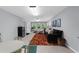 A finished basement boasts a cozy living area with a comfortable sofa and ample natural light from the exterior windows at 3445 Strawberry Ln, Cumming, GA 30041