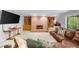 Inviting living room featuring a brick fireplace, built-in shelving, and plush leather seating for cozy gatherings at 3445 Strawberry Ln, Cumming, GA 30041