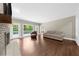 Bright and airy living room with a brick fireplace, hardwood floors, and lots of natural light with access to the patio at 3445 Strawberry Ln, Cumming, GA 30041