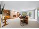 Spacious living room with a brick fireplace, built-in bookshelves, and a comfortable leather sofa, perfect for relaxation and entertainment at 3445 Strawberry Ln, Cumming, GA 30041