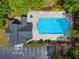 Aerial view of a well-maintained community pool and clubhouse nestled among lush trees and parking area at 1552 Brentwood Dr, Marietta, GA 30062
