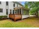 Exterior view of the screened-in porch and deck with an adjacent well-maintained green lawn at 1552 Brentwood Dr, Marietta, GA 30062