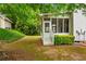Charming screened-in porch addition with white railings, a step-down staircase and lush surrounding foliage at 1552 Brentwood Dr, Marietta, GA 30062