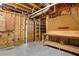 Unfinished basement with exposed beams, pegboard, a workbench and access to other areas of the home at 1552 Brentwood Dr, Marietta, GA 30062