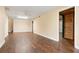 Finished basement with dark wood floors, neutral walls, and a door to another room at 1552 Brentwood Dr, Marietta, GA 30062