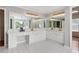 Spacious bathroom with double sinks and vanity, with white tiled floors and bright vanity lighting at 1552 Brentwood Dr, Marietta, GA 30062